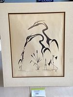 Frontal photo of the numbered print featuring stylized black ink birds and abstract plants, dated 2023