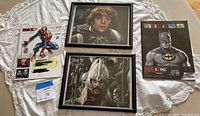 Framed autographed photos of Lord of the Rings characters, displayed with Fan Expo badges and brochures