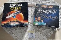 Photo of both Star Trek Catan and Star Trek Scrabble board games together on a table with lace tablecloth.