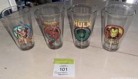 Four Marvel superhero drinking glasses arranged side by side: Thor, Spider-Man, Hulk, Iron Man, each with colorful superhero images and text.