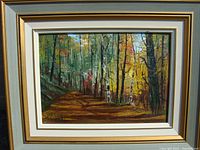 Framed oil painting showing a country road through autumn trees, signed Hitchcock lower left.