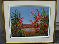 Full view of the framed colorful autumn landscape painting showing composition and framing.