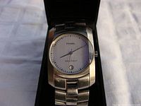 Front view of the Fossil Arkitekt wristwatch inside a black box showing the dial and part of the band.