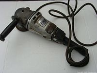 Overall view of the Black & Decker angle sander showing body, handle, and attached power cable.