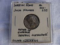 Obverse view of coin in plastic holder with handwritten identification