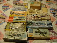 Overview of multiple model kits in assorted scales and subjects including aircraft and ships.
