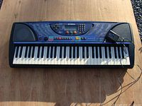 Front view of Yamaha PSR-248 keyboard showing full 61 keys, speakers, and control panel with buttons and song list.