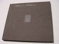 The hardcover collection book shows a dark brown textured cover with silver foil stamping of 'Canada Post The Millennium Collection 2000'.