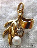 Frontal view of pendant showing leaf motif, diamond and pearl