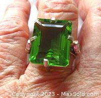 Front view showing vibrant green emerald cut quartz and prong setting