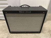 Front view showing grille cloth, Fender Deluxe badge and overall condition