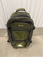 Front view of green Roots suitcase showing main zippered compartments and front logo.