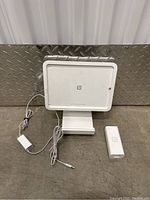 White Square card reader with power adapter and stand, showing packaged contents and cables.