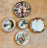 Top-down view of the five Japanese ceramic items showing designs and size variety.