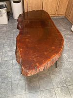 Top view of the redwood burl coffee table showing irregular shape and gloss finish with profile edges.