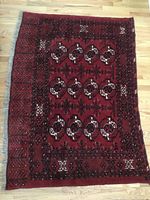 Full view of the antique camel blanket laid flat on floor showing overall pattern and condition