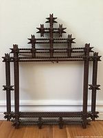 Full front view of tall rectangular dark wood Victorian gothic picture frame with detailed zigzag carving and pointed cross motifs on upper section.