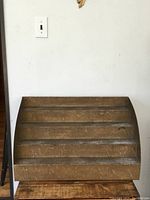 Front view of the metal stair display showing four display steps and surface wear.