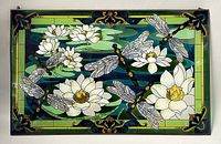 Full frontal view of rectangular stained glass panel showing entire dragonfly and floral design