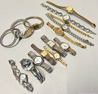 Top-down view of all watches laid out showing variety of styles and band types