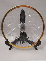 Top view of the crystal fruit plate showing clear geometric facets and gold rim.