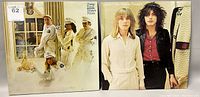 Photo showing both Cheap Trick vinyl albums: 'Dream Police' with band in white police uniforms, and 'Heaven Tonight' with two band members on cover.