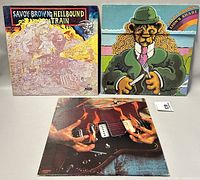 Three Savoy Brown vinyl albums displayed showing front covers, including Hellbound Train, Lion's Share, and a guitar-cover album.