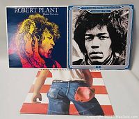 Front covers of three vinyl records showing Robert Plant's "Manic Nirvana," Jimi Hendrix's "The Essential Jimi Hendrix Volume Two," and Bruce Springsteen's "Born in the U.S.A."