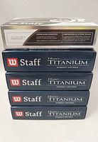 Five boxes of Wilson Staff Hyper Titanium golf balls stacked with markings visible