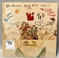 Folded album cover showing children’s artwork with handwritten text 'John Lennon June 1952 AGE 11 Walls and Bridges' and figures playing soccer.