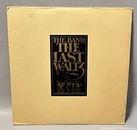Front cover of The Band 'The Last Waltz' 4-record set in cream color with black and gold lettering.