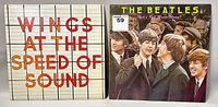 Photo showing two vinyl album covers, Wings 'At The Speed Of Sound' and The Beatles 'Rock 'n' Roll Music Volume 1'.