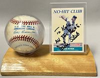 Signed Dave Stieb baseball card with personalized inscription displayed next to an Official American League Rawlings baseball on a wooden base.