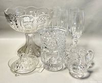 Photo showing all items in the vintage glassware set including footed compote bowl, vase, juicer, flutes, creamer, and sugar bowl, arranged together.