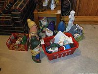 Overview of lot showing multiple painted gnomes, red tubs with small figures, unpainted statue and paint jars