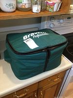 Green padded travel bag with Bravetti Professional branding and zipper closure.