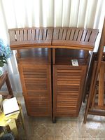 Front view of teak bar cabinet with folding top closed