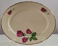 Top view showing the entire large oval platter with pink roses and gold trim.