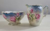 Full view of the hand painted Silesia creamer and open sugar bowl set showing floral patterns and gold accents.