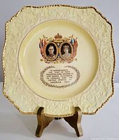 Full view of the square-shaped collector plate with decorative embossed border, gold trim, and central design of King George VI and Queen Elizabeth.