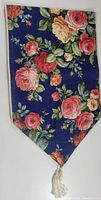 Photo showing full triangular end of the table runner with floral pattern and tassel edging