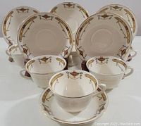 Full set of six cups paired with six saucers arranged facing forward, showing overall design and condition.