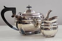 Photo of the teapot and creamer set showing polished silver finish and Art Deco design.