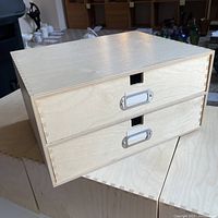 Closed view of a wooden 2-drawer filing unit showing dovetail joints and metal label holders on drawers