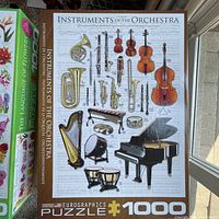 Puzzle titled Instruments of the Orchestra showing musical instruments illustrated over a musical notes background.