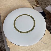 Top-down view of the round white LED ceiling light fixture displaying the gold ring accent in the center.