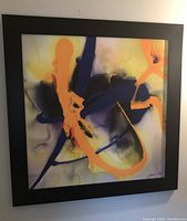 Frontal view of the framed abstract painting by James Lane with vibrant brush strokes in orange, blue, and black.