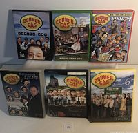 Front view showing DVD cases for Corner Gas Seasons 1 to 6 with distinctive cover art and cast photos.