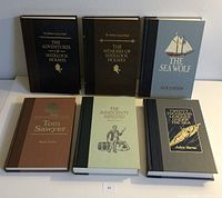 Front view of six hardcover Reader's Digest classic books arranged in two rows on a neutral surface. Titles visible on front covers.