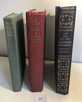 Three vintage hardcover books side by side, showing spine titles: Ten Days That Shook the World (green spine), The Alaskan (red spine), Life and Letters of Benjamin Franklin (black spine with gold decorative text).